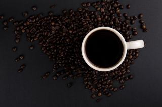Gousses de cardamome verte et petite tasse de café sur un plateau de cuivre